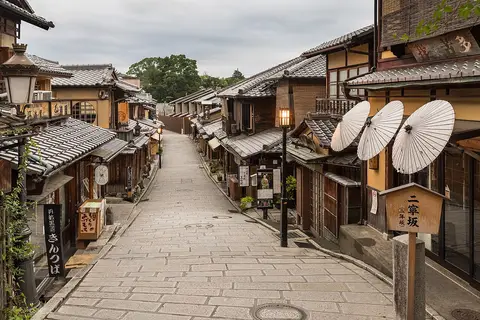 Stone-paved lane with paper umbrellas in Higashiyama, Kyoto